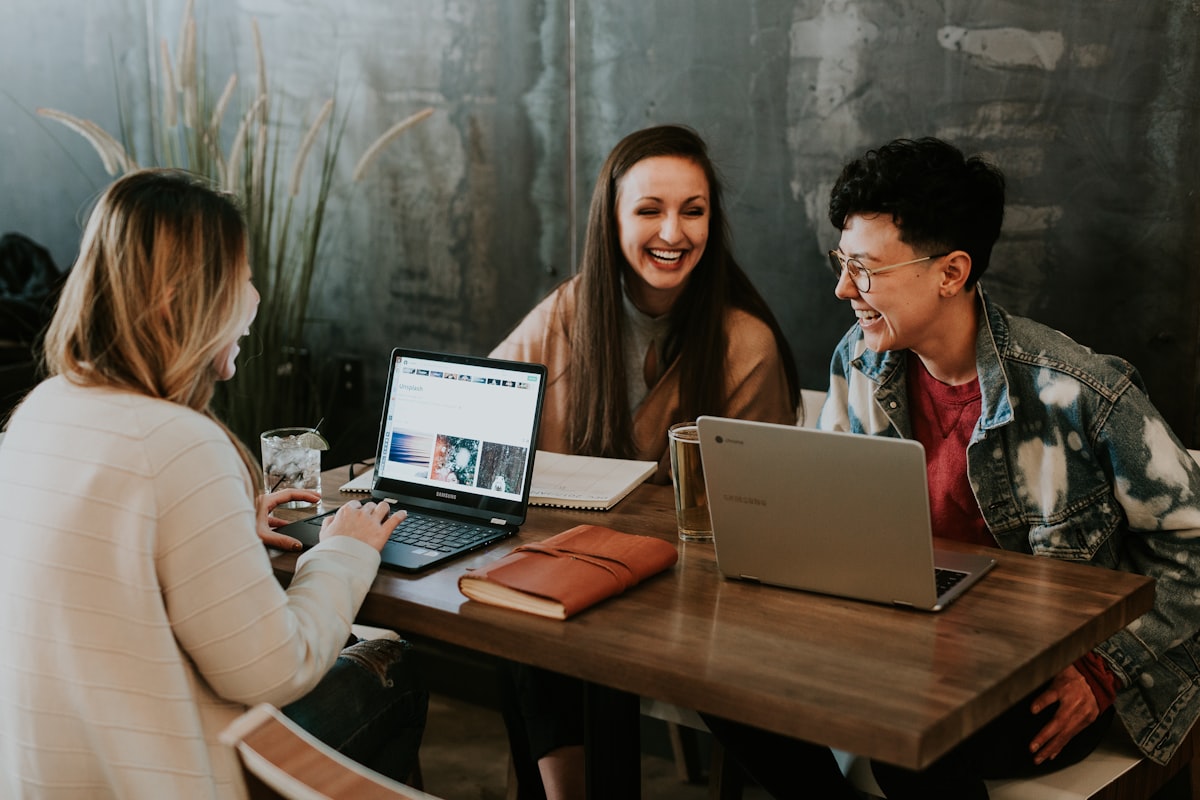 Small business team reviewing a website on a laptop in a bright office